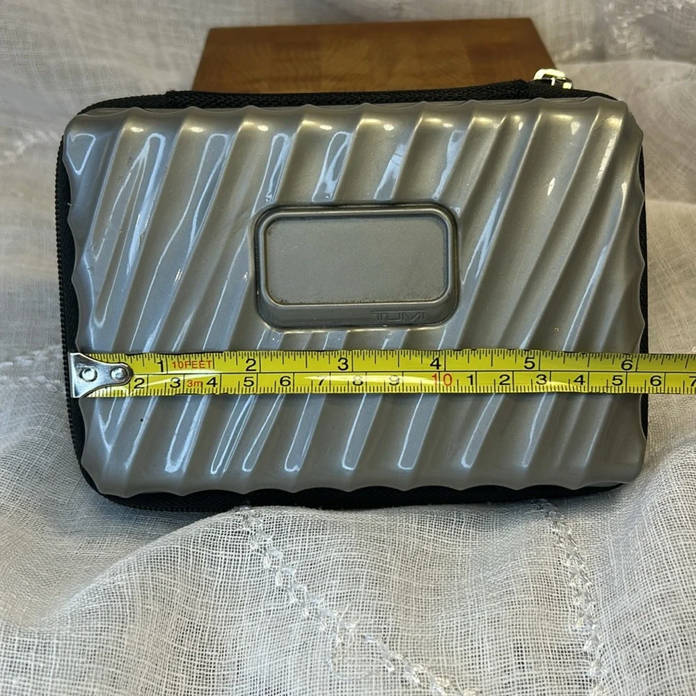 Tumi hard case luggage cosmetic bag filled with goodies for your next trip